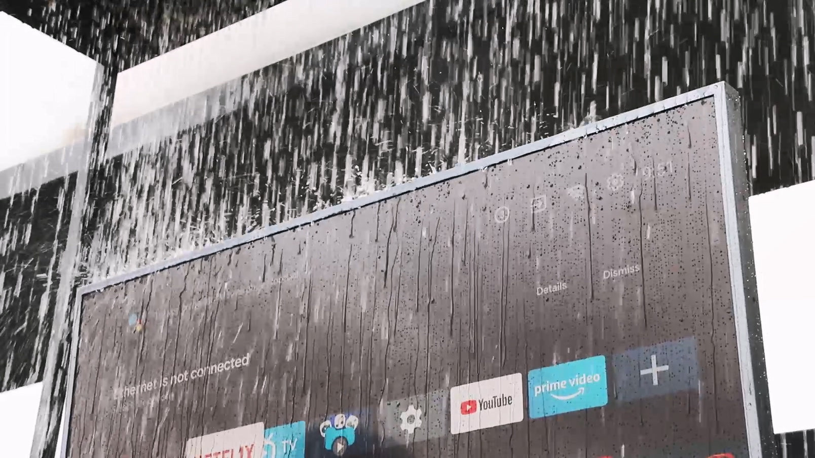 Sylvox IP56 waterproof outdoor TV playing sports in heavy rain, fully functional despite downpour