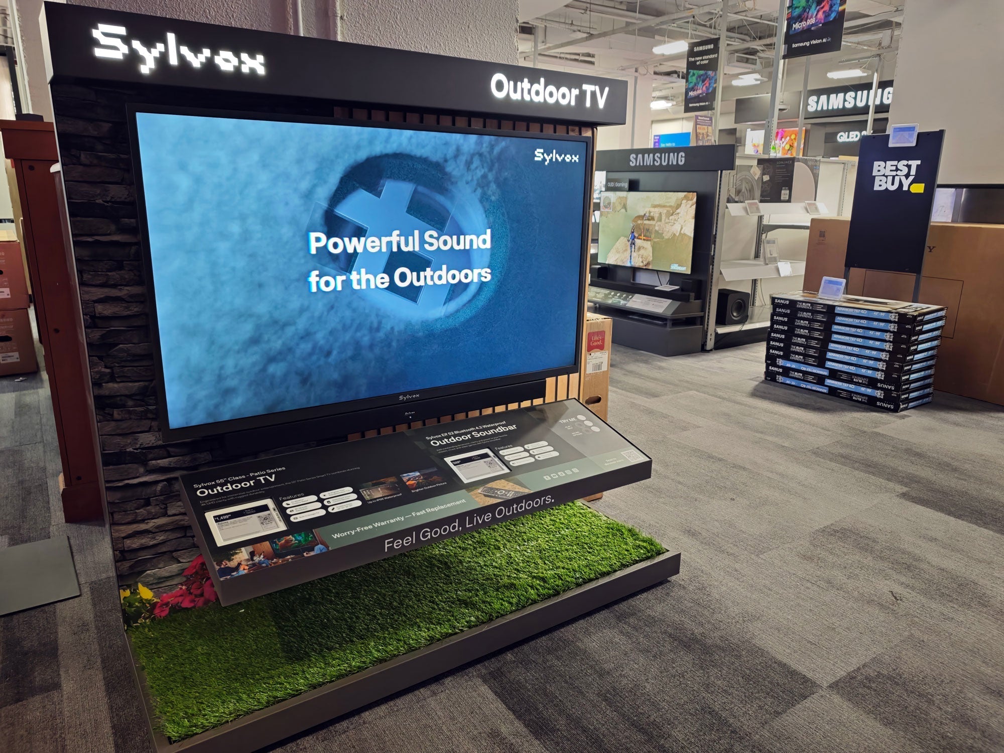 Sylvox Outdoor TV display inside a Best Buy store with demo screen and soundbar setup